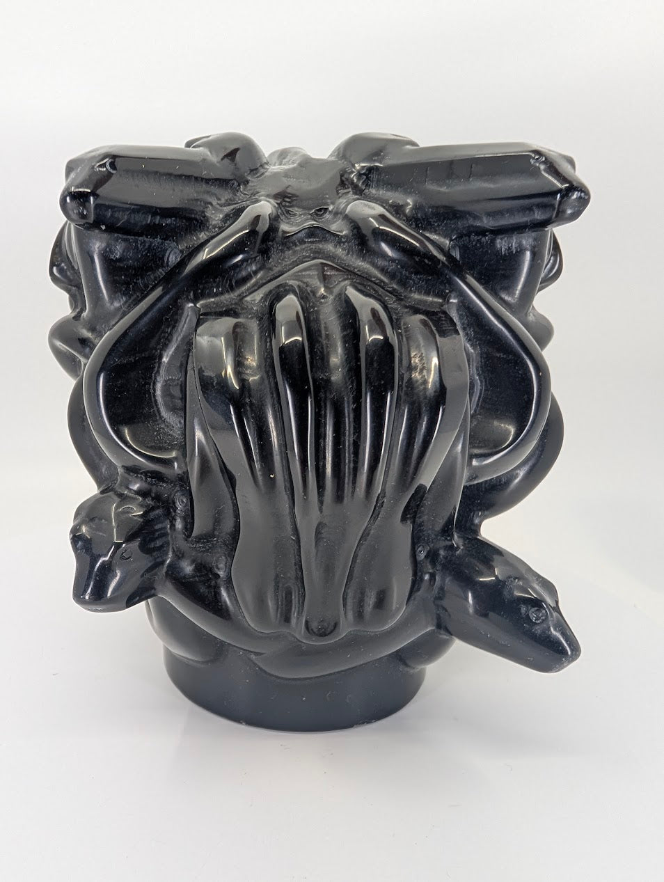 Back view highlighting carved snakes and flowing hair