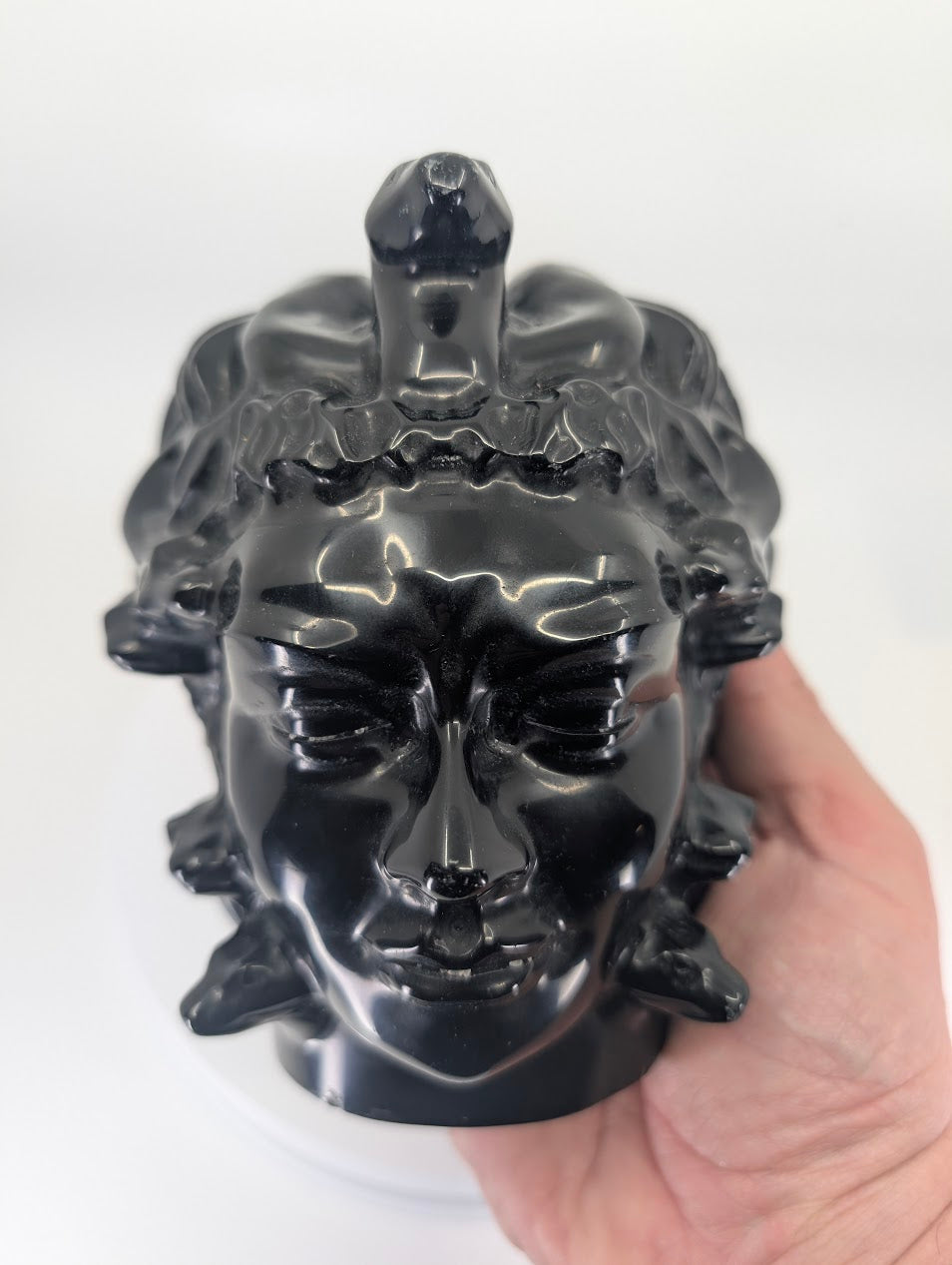 Medusa carving held in hand for size and scale