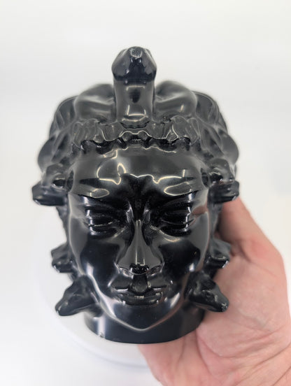 Medusa carving held in hand for size and scale