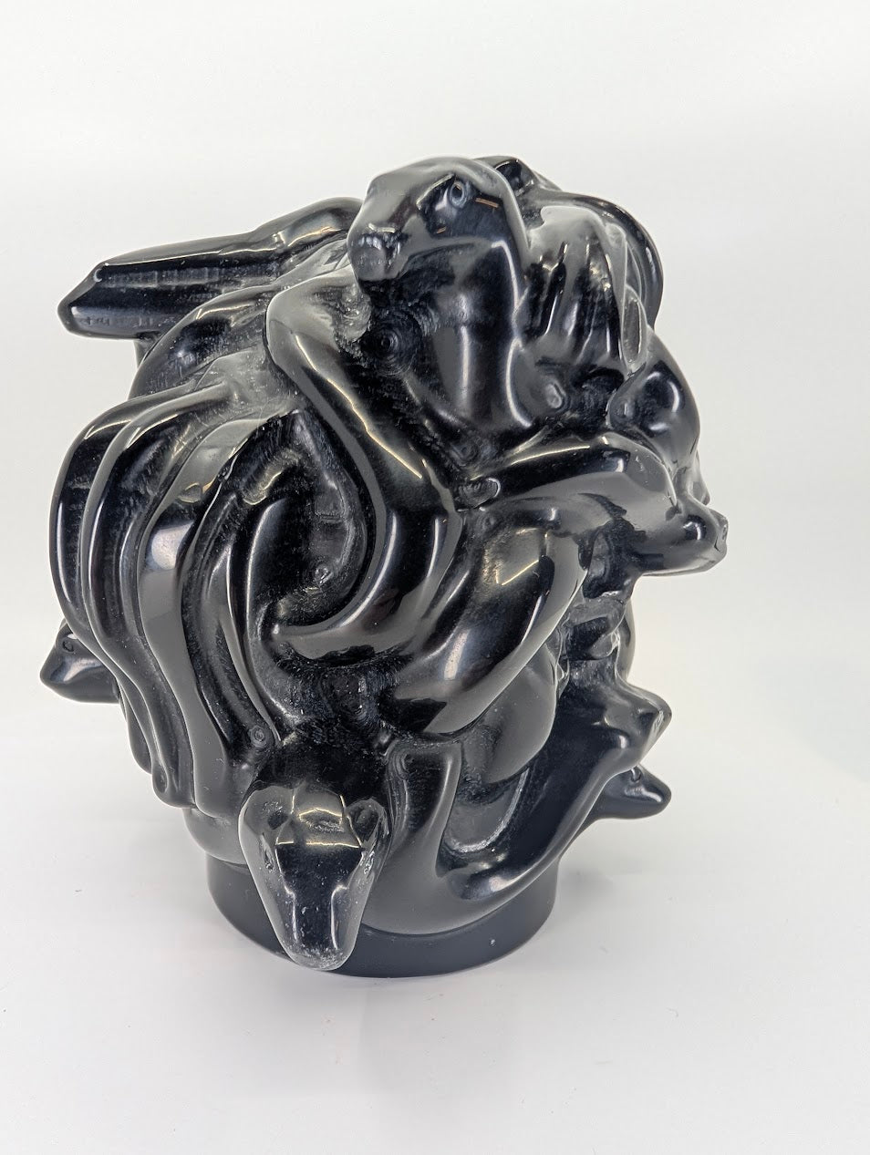 Right-angle view of polished obsidian Medusa sculpture