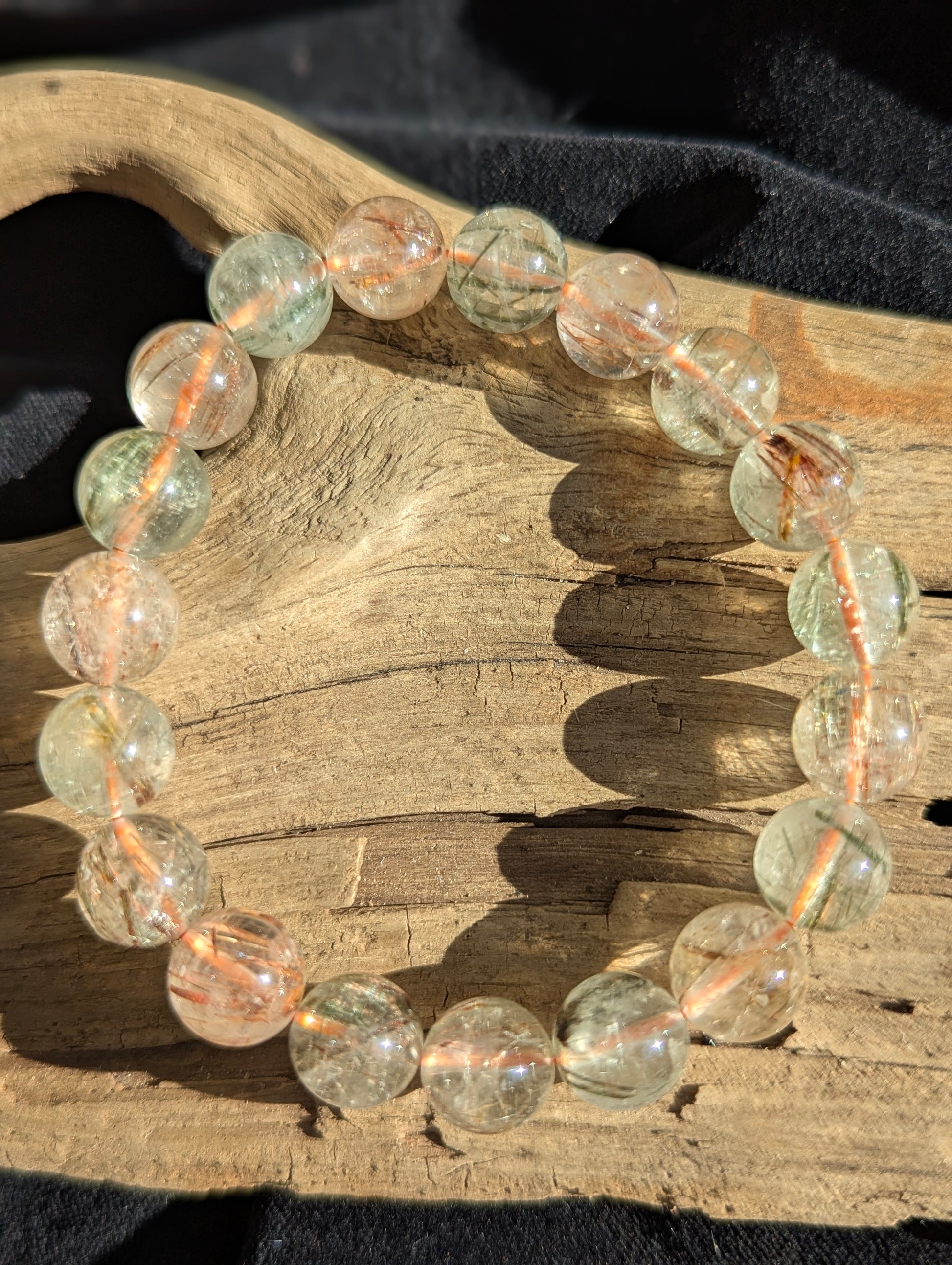 An 11mm bead stretch bracelet of premium Brazilian black and red rutilated quartz showing exceptional optical clarity and vivid colour zoning.