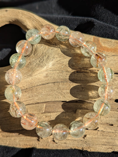 An 11mm bead stretch bracelet of premium Brazilian black and red rutilated quartz showing exceptional optical clarity and vivid colour zoning.