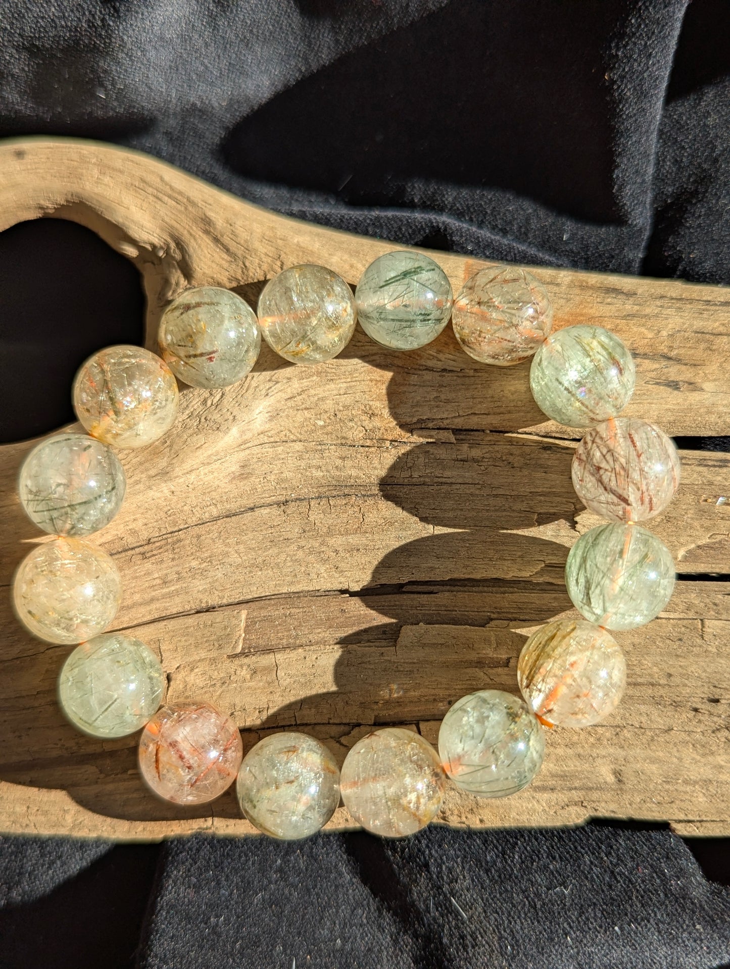 A large 14mm statement stretch bracelet crafted from AA-grade Brazilian black and red copper rutilated quartz, highlighting the chaotic internal metallic structures.