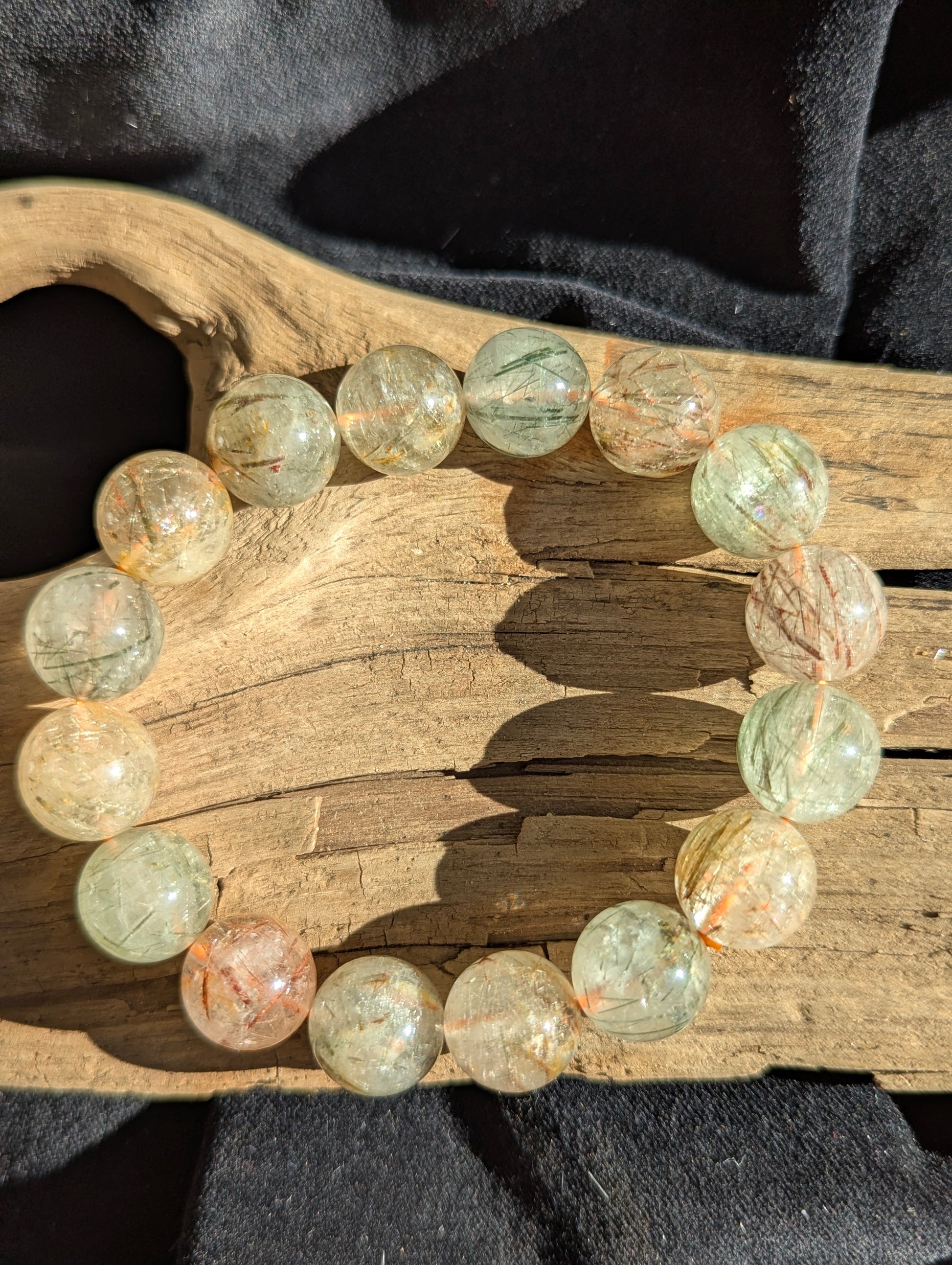 A large 14mm statement stretch bracelet crafted from AA-grade Brazilian black and red copper rutilated quartz, highlighting the chaotic internal metallic structures.