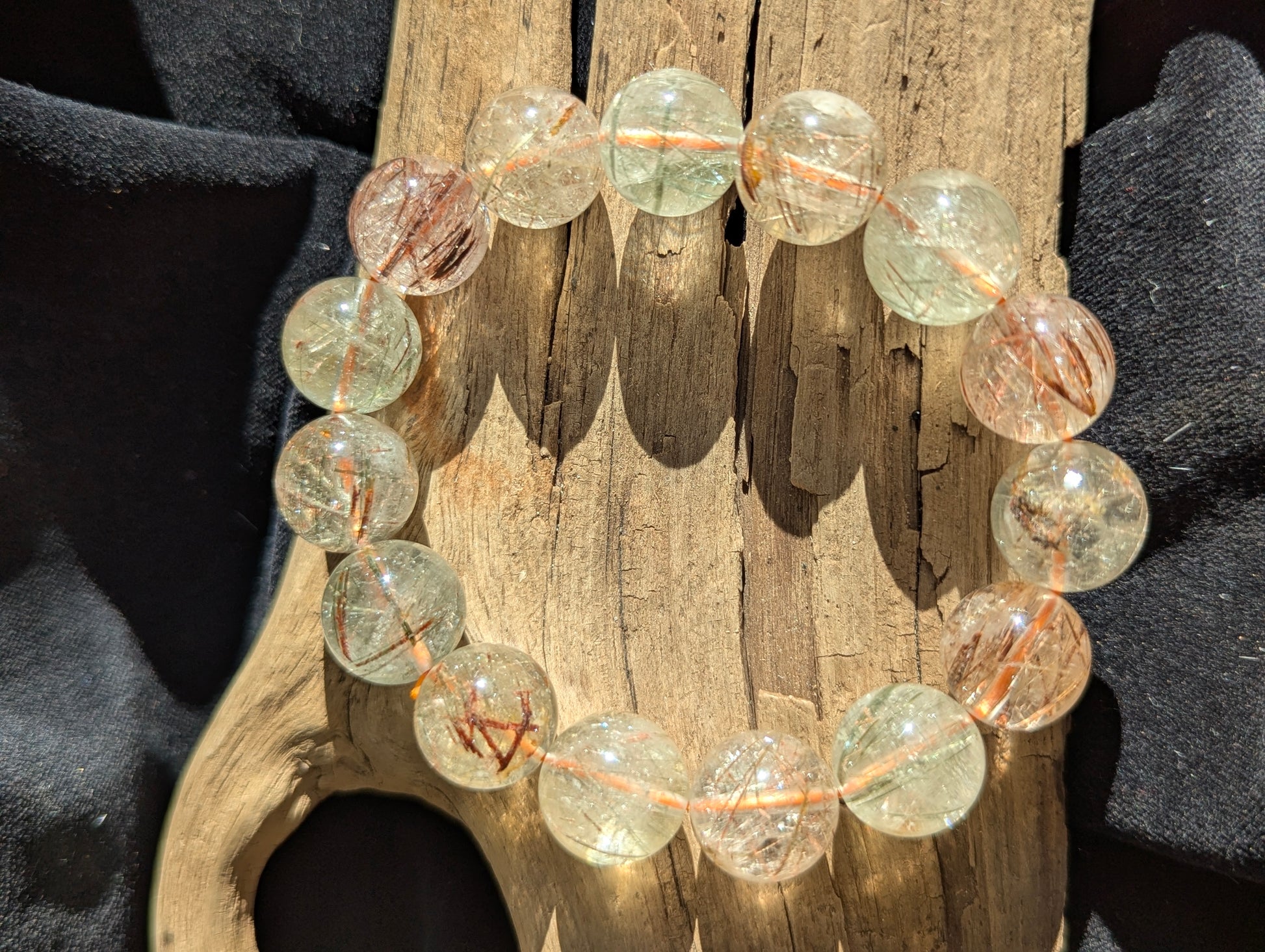 A massive 15mm statement stretch bracelet crafted from AA-grade Brazilian black and red copper rutilated quartz, highlighting the chaotic internal metallic structures.