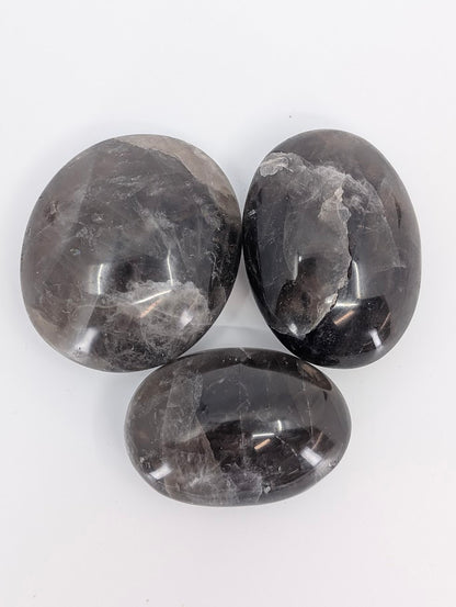 Top view of three palms with pattern variation