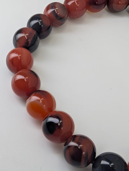 Angled detail of Black Sardonyx bracelet highlighting glossy finish and colour contrast