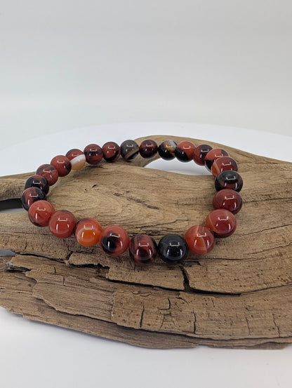 Black Sardonyx bracelet on driftwood showing red and black banded beads