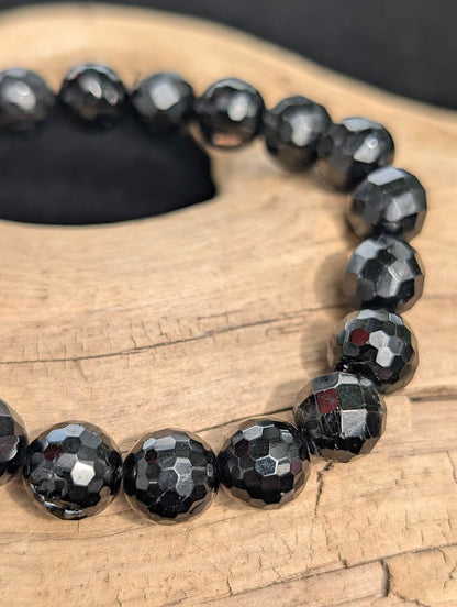 Macro close-up of 10mm faceted Black Tourmaline beads.