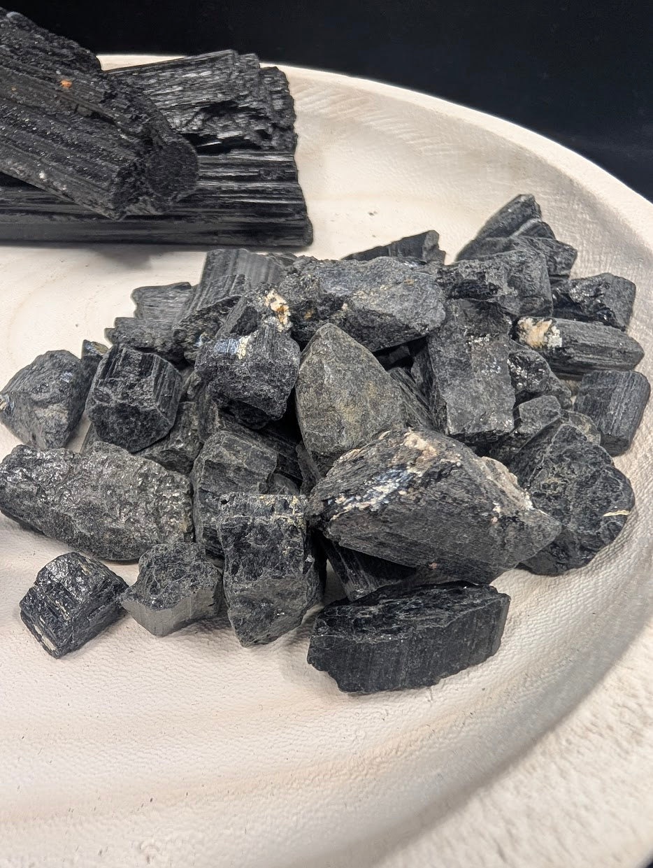 A pile of small, raw Black Tourmaline shards and chunks suitable for 25g loose sets and crystal grids.