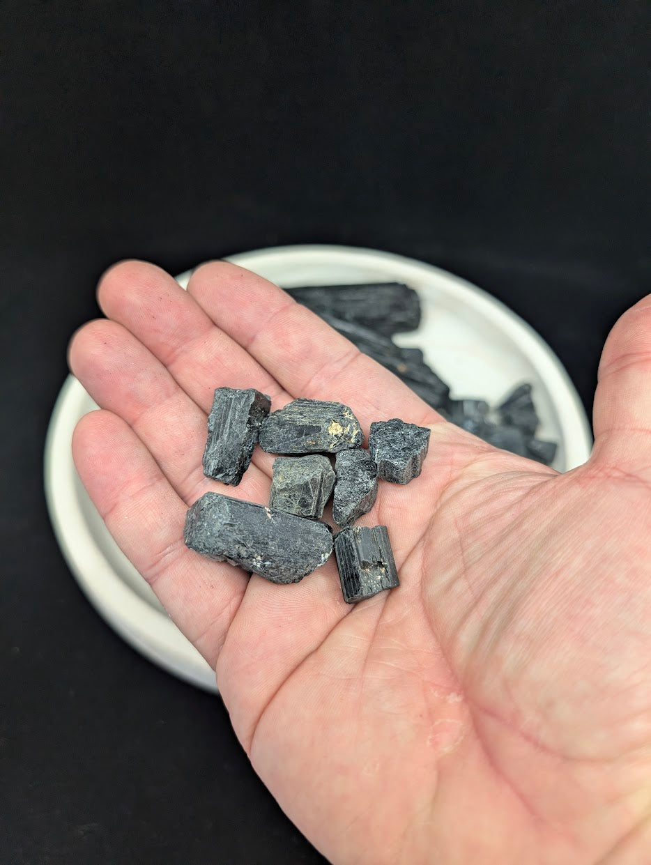 Handful of small Black Tourmaline pieces showing the typical size and quantity of a 25g loose-variant set.