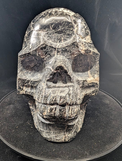 Front view of Black Tourmaline Skull — 4 kg polished carving with natural striations
