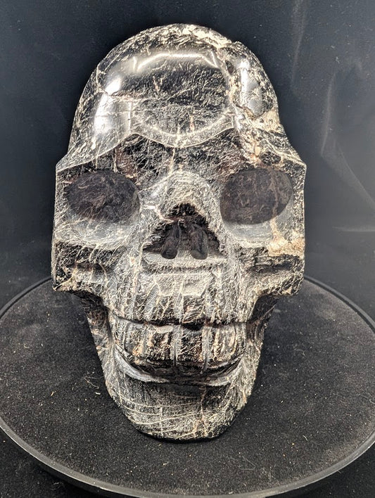 Front view of Black Tourmaline Skull — 4 kg polished carving with natural striations