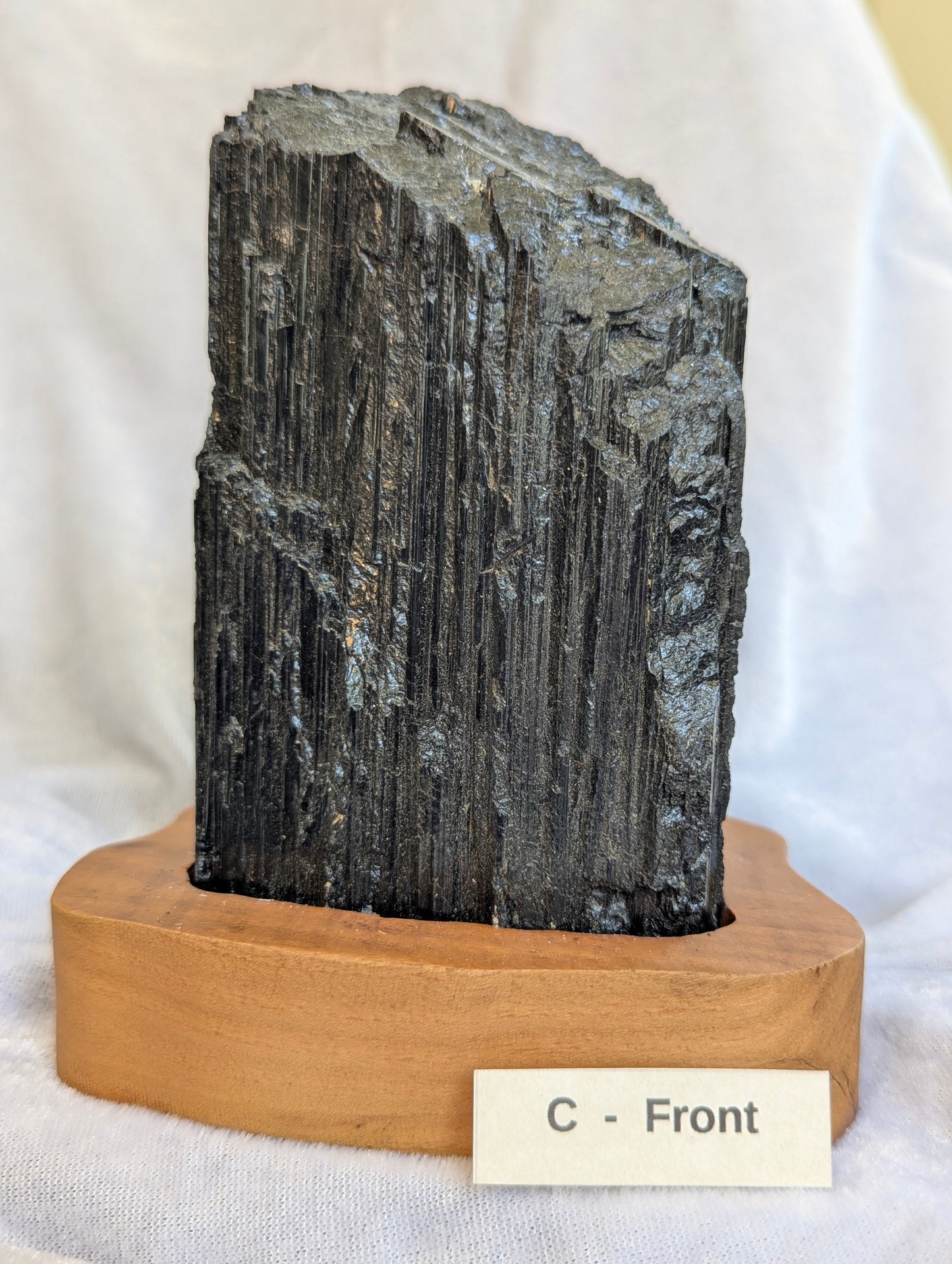 1.11kg large raw Black Tourmaline tower showing massive crystal growth on stand.