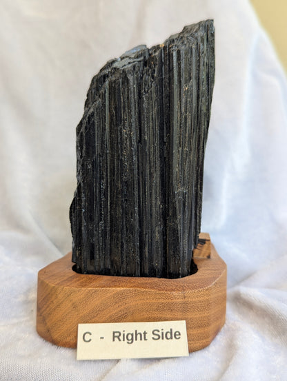 1.11kg large raw Black Tourmaline tower showing massive crystal growth on stand.