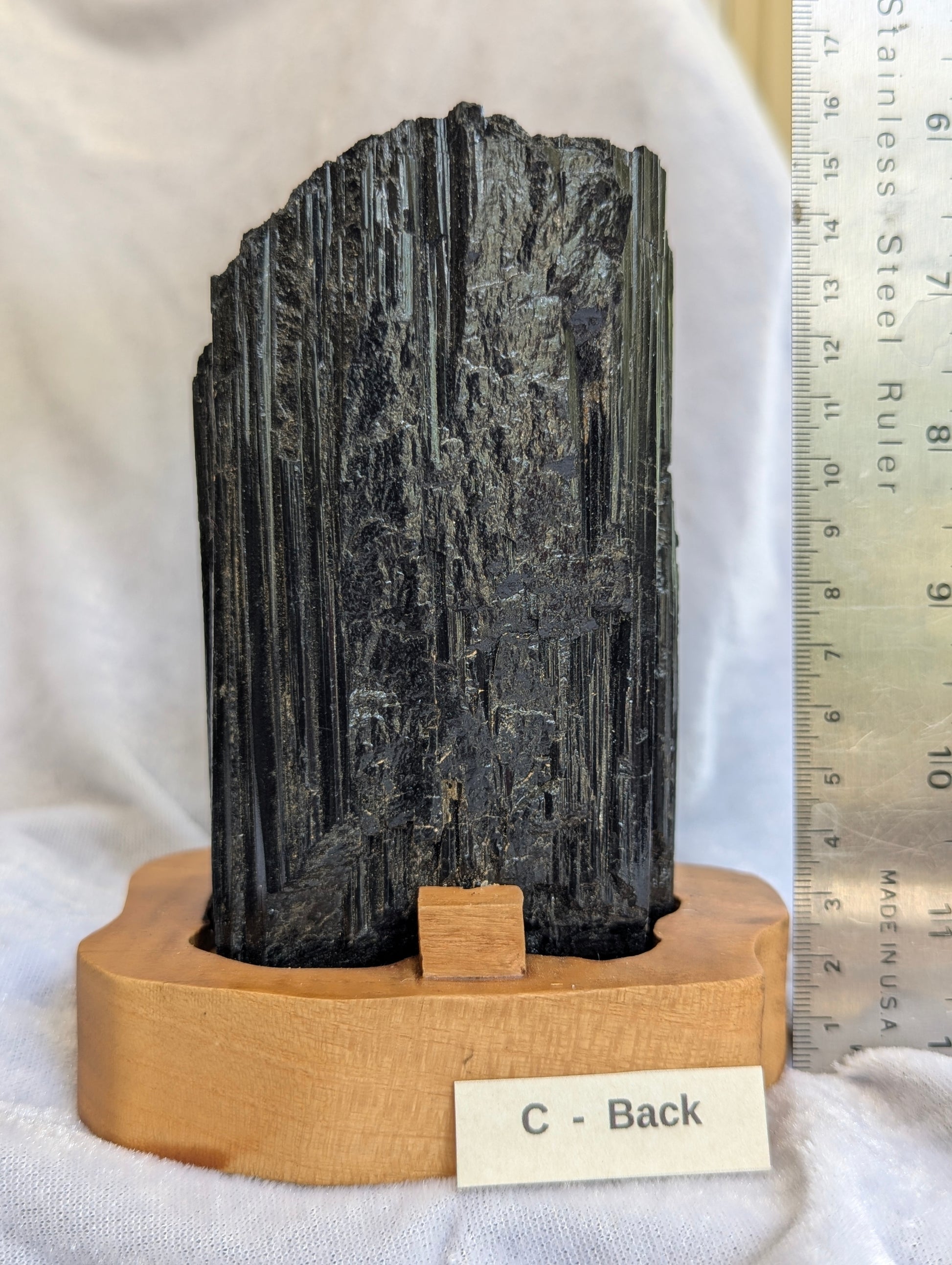 Scale reference view of 1.11kg raw Black Tourmaline tower on display.