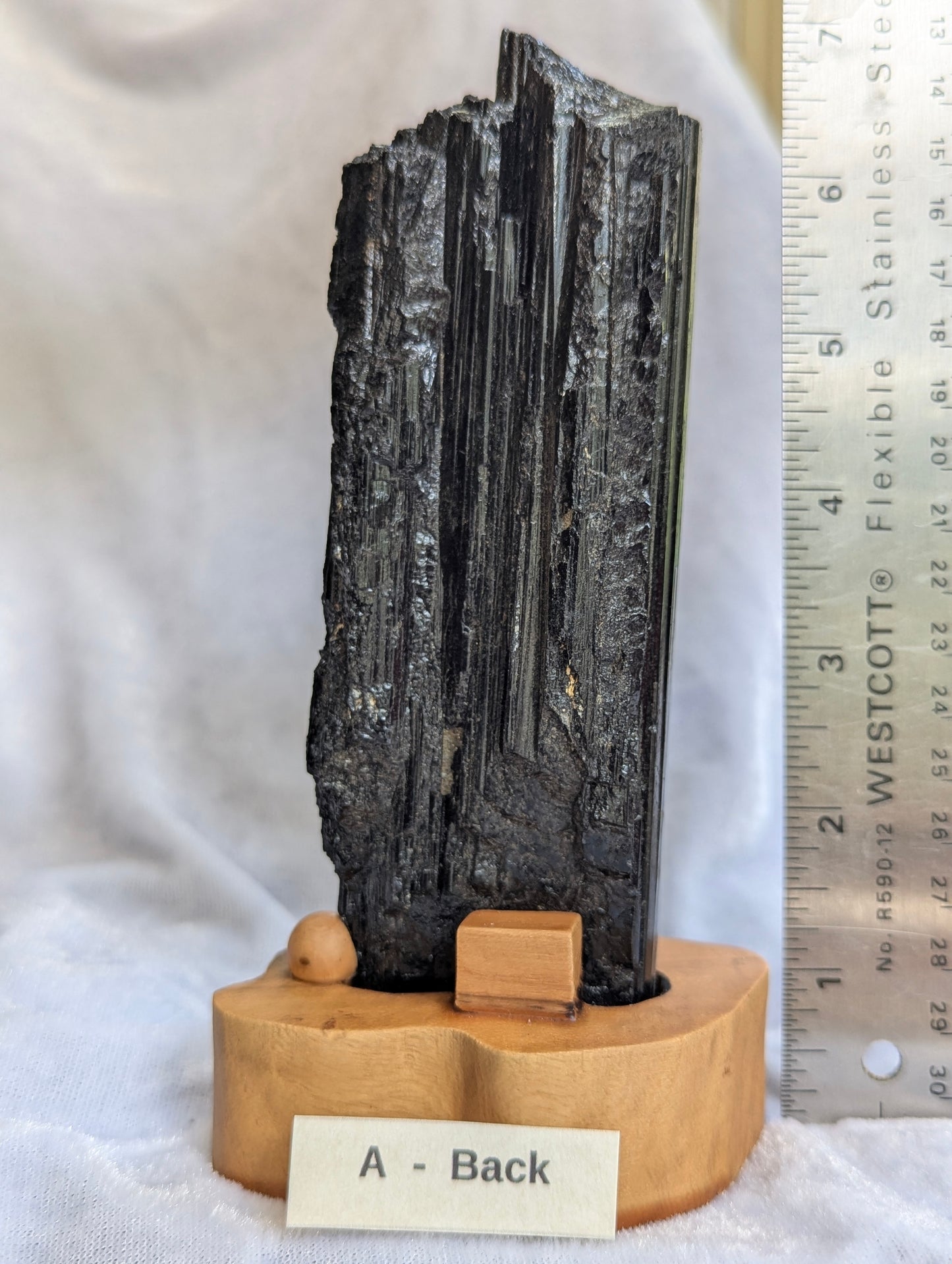 back profile of 390g raw Black Tourmaline tower showcasing natural crystal growth.