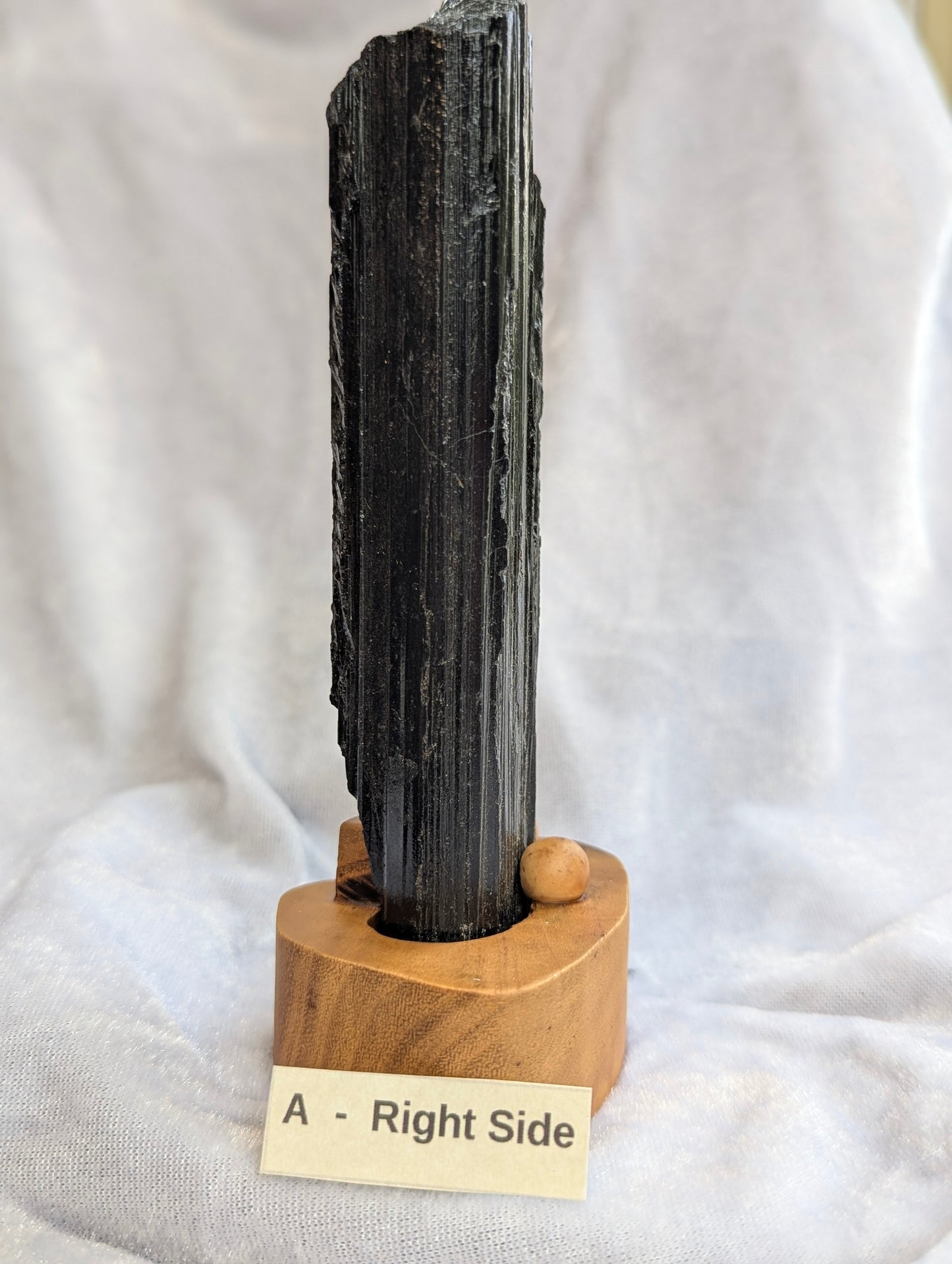Side profile of 390g raw Black Tourmaline tower showcasing natural crystal growth.