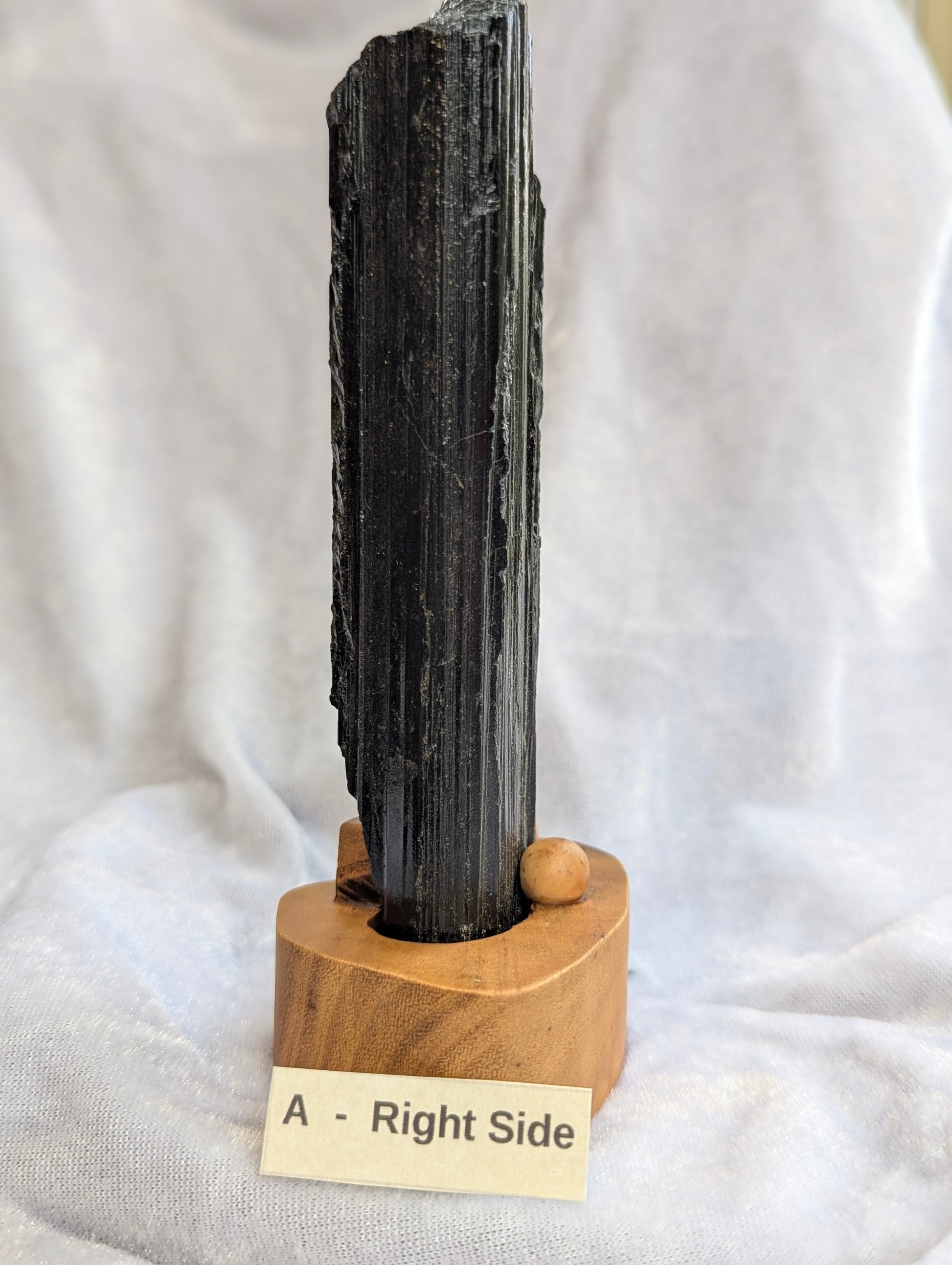 Side profile of 390g raw Black Tourmaline tower showcasing natural crystal growth.