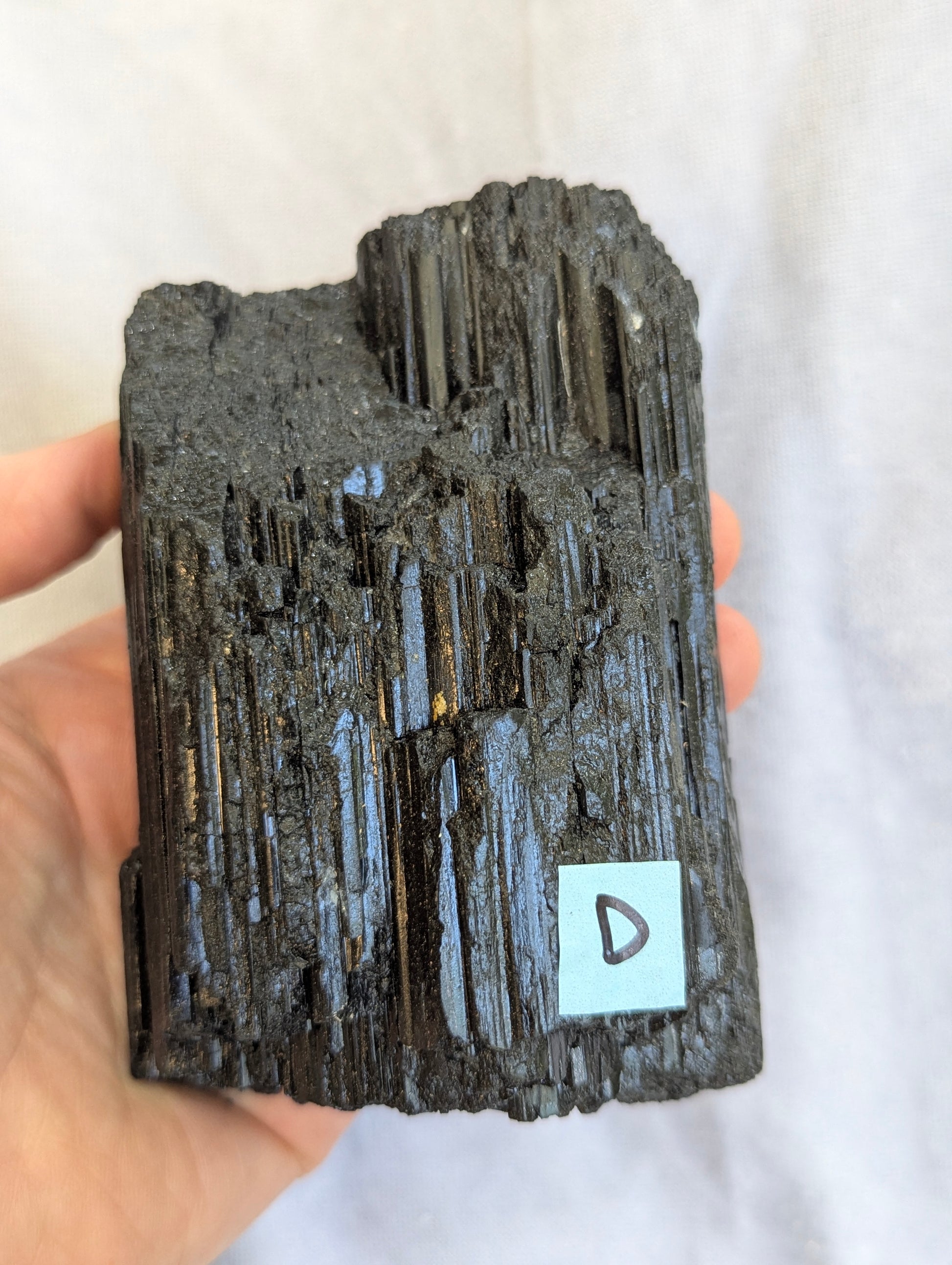 Hand Held View of termination on 680g raw Black Tourmaline tower.