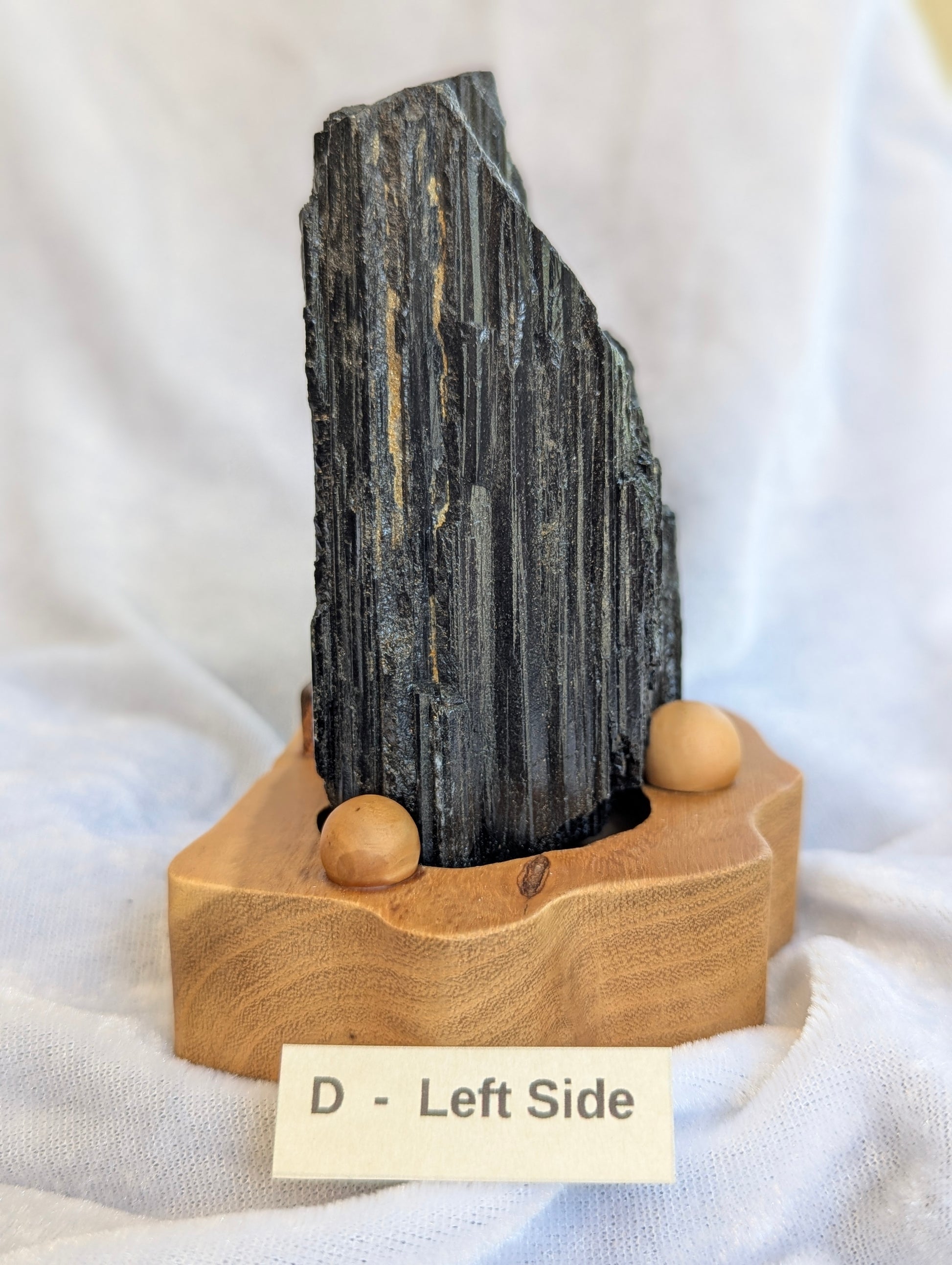 Profile view of 680g raw Black Tourmaline tower demonstrating structural height.