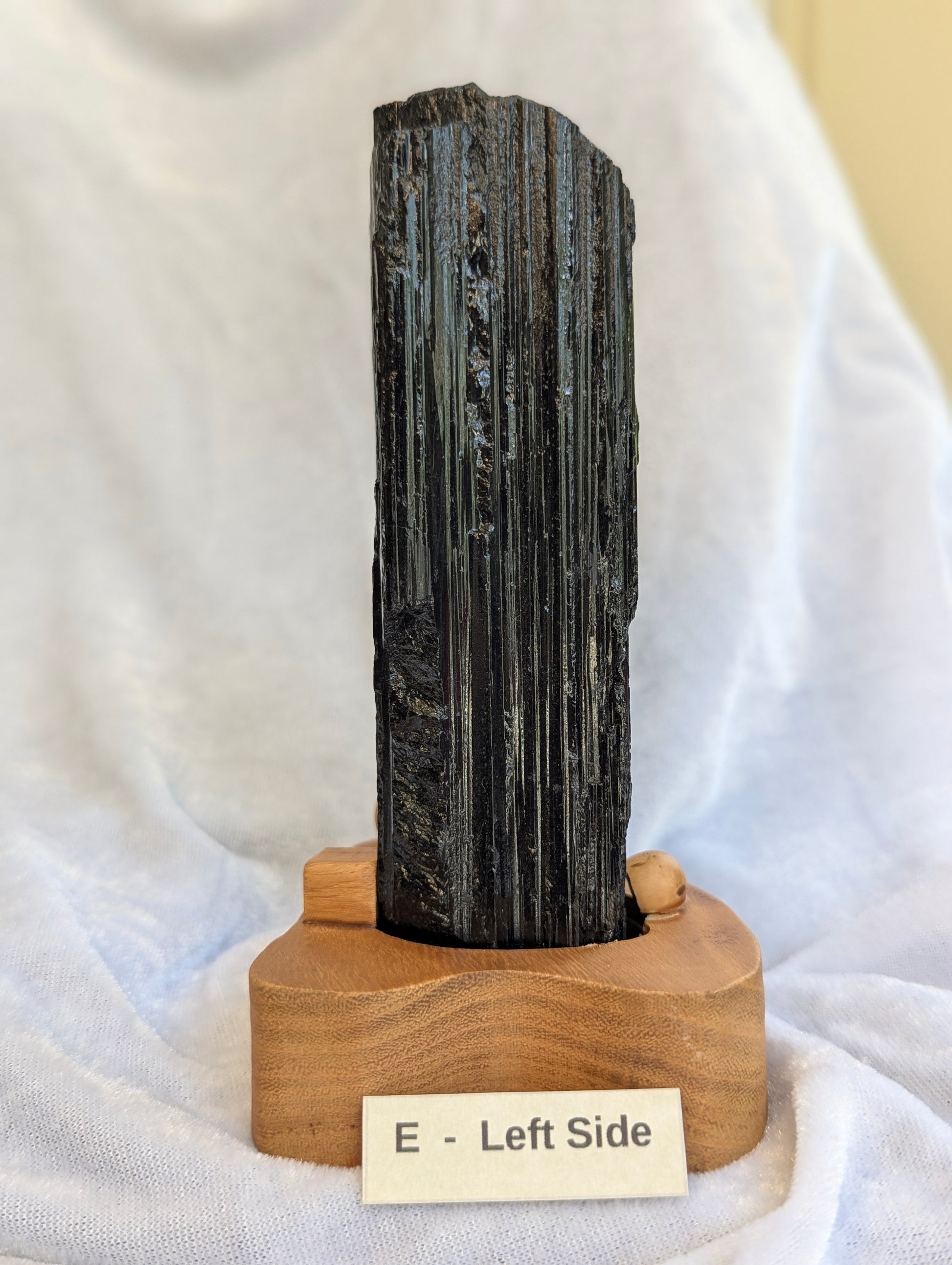 Left side Side profile of 700g raw Black Tourmaline tower on stand.
