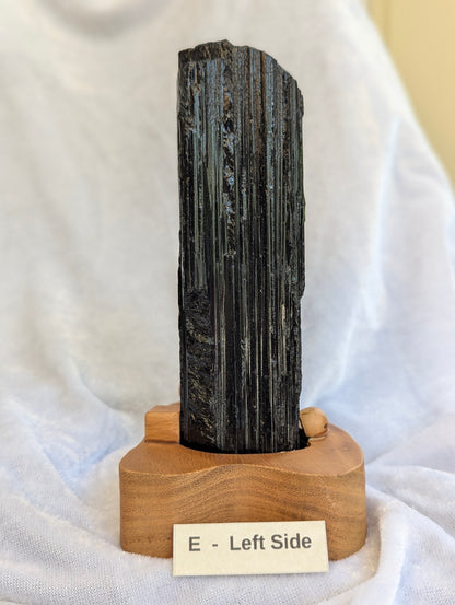 Left side Side profile of 700g raw Black Tourmaline tower on stand.