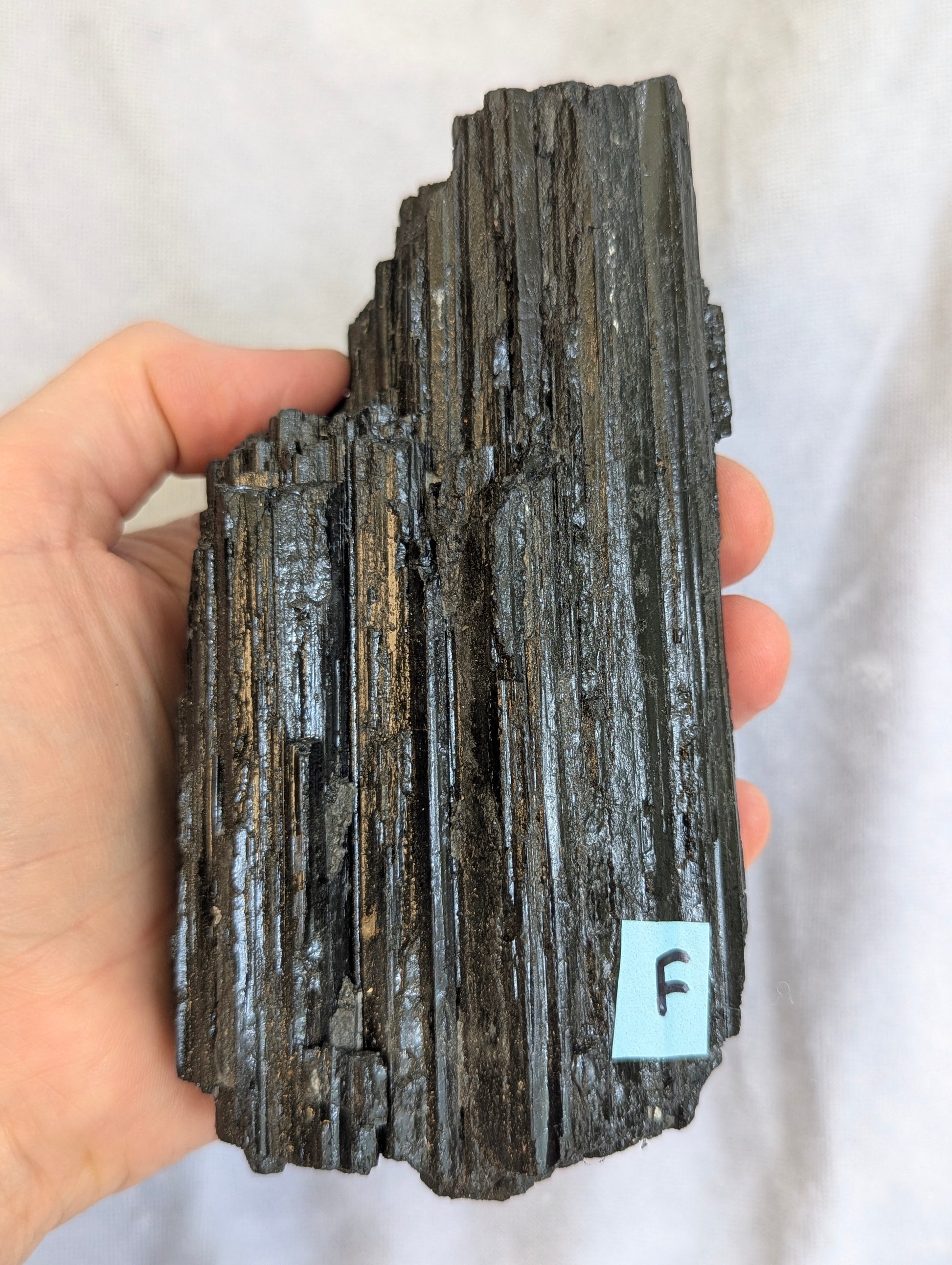 Macro detail of Black Tourmaline tower crystal surface.
