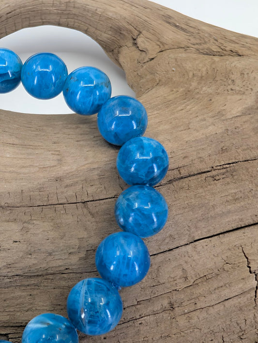 Side profile detail of Blue Apatite beads highlighting the smooth polish and consistent 8mm spherical form.