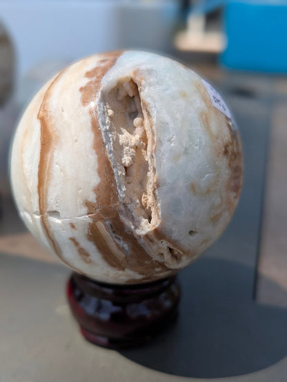 Reverse view of the exact 71mm Blue Aragonite sphere displaying a deep, unpolished vertical vug with natural botryoidal crystals.
