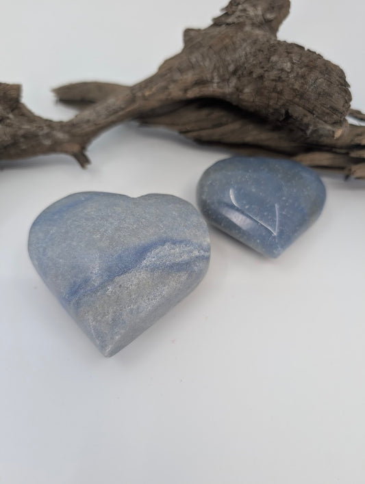 Pair of Blue Aventurine hearts showing soft denim blue color on driftwood.