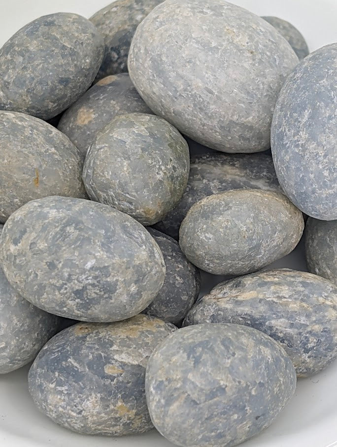 Close-up of Blue Calcite tumbled stones showing natural texture