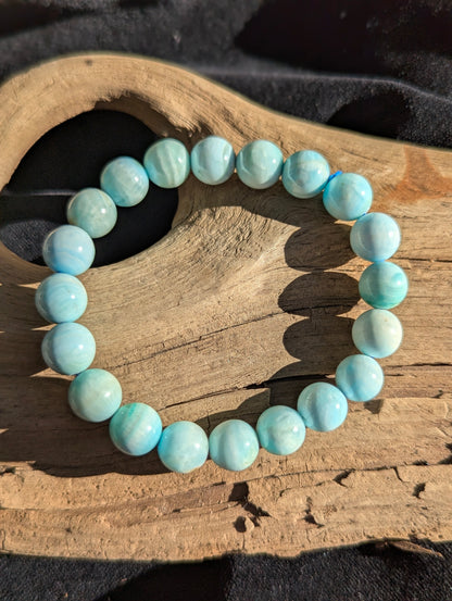 A premium 9mm Blue Hemimorphite beaded stretch bracelet featuring 20 polished spheres with distinctive cloudy white and blue zoning.