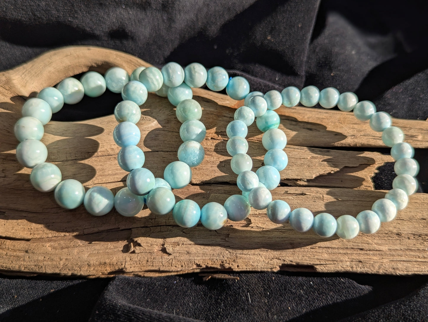 A selection of premium Blue Hemimorphite beaded stretch bracelets displayed together on a tray, showcasing 8mm, 9mm, and 10mm options