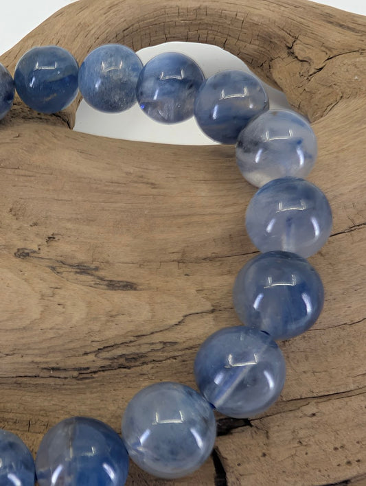 Close-up of 9mm Blue Kyanite beads highlighting the natural silky luster and bladed crystal structure.