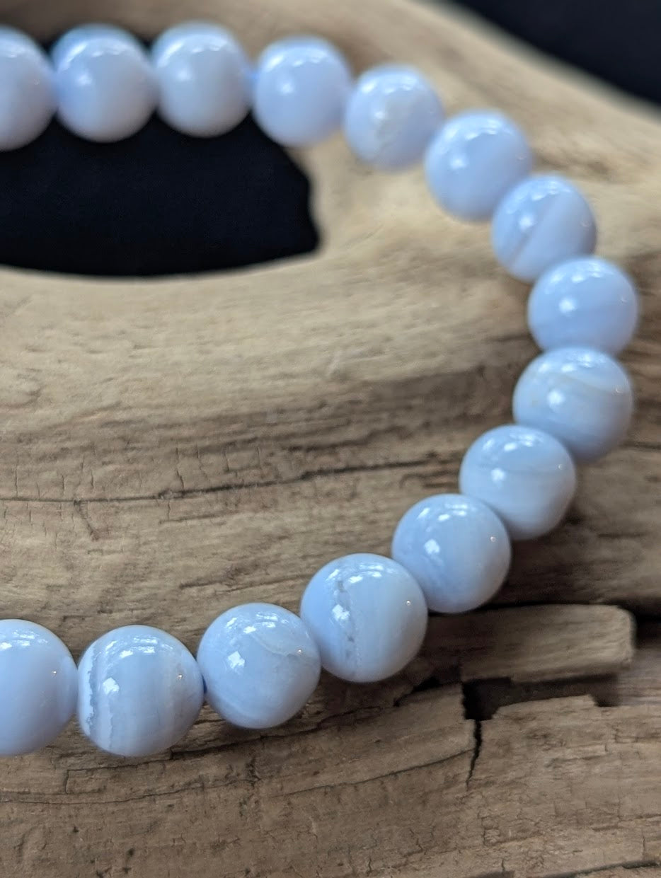 Detailed close-up of an 8mm Blue Lace Agate bracelet showing soft periwinkle blue and white chalcedony layers.