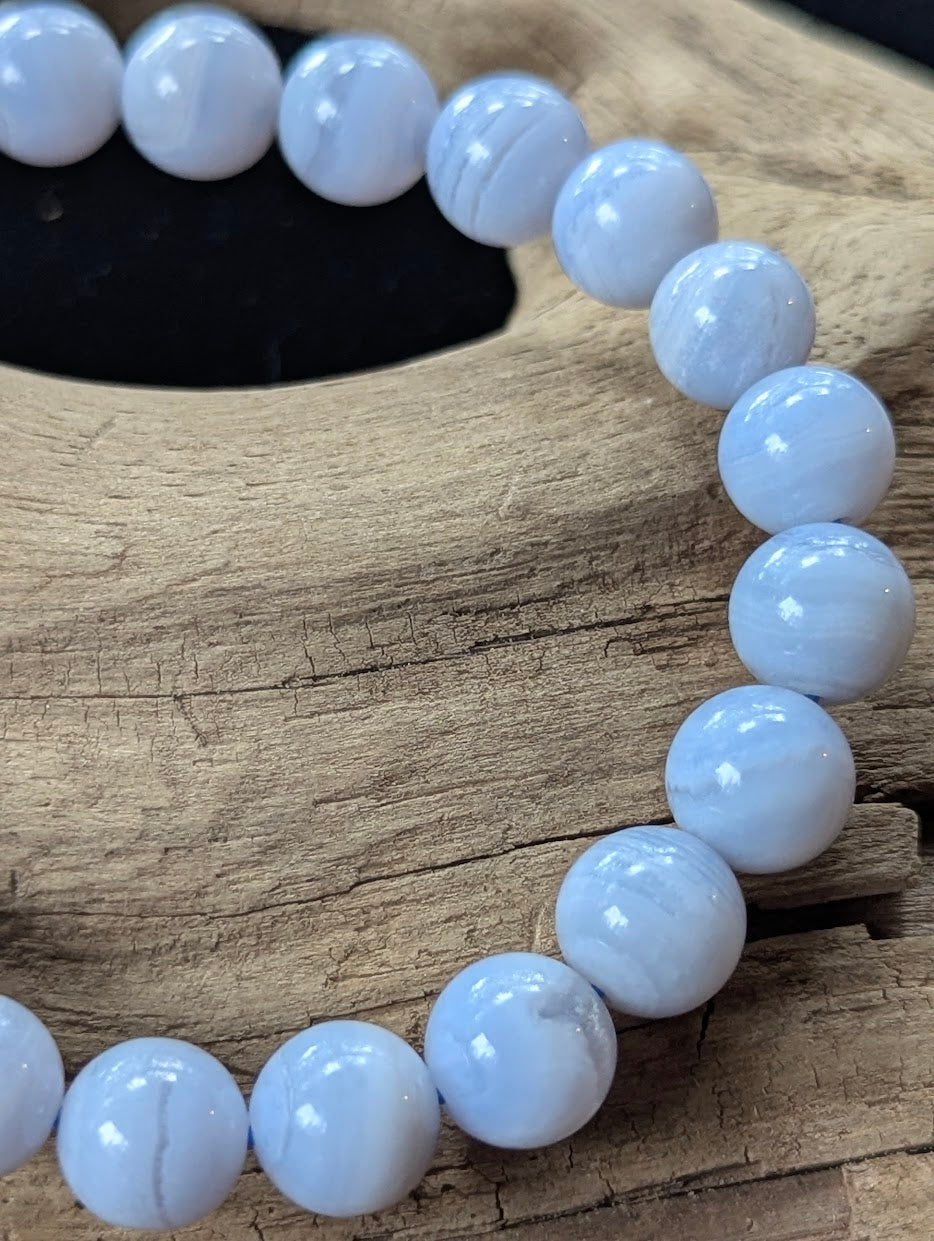 Close-up of a 9mm Blue Lace Agate bracelet showing distinct natural white lace patterns.
