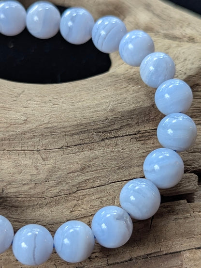 Close-up of a 9mm Blue Lace Agate bracelet showing distinct natural white lace patterns.