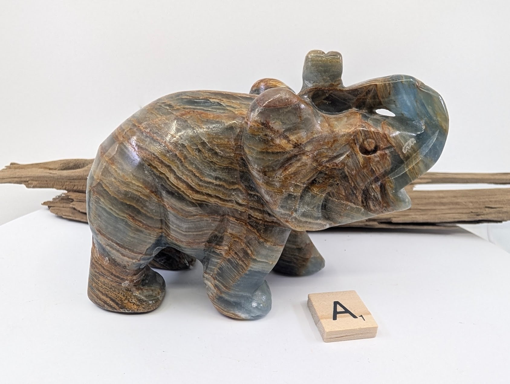 Hand-carved Blue Onyx (Banded Calcite) elephant specimen A1 from Argentina showing blue and honey-gold banding.