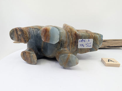 Underside of Blue Onyx elephant specimen A1 showing weight label 481g and raw calcite texture.