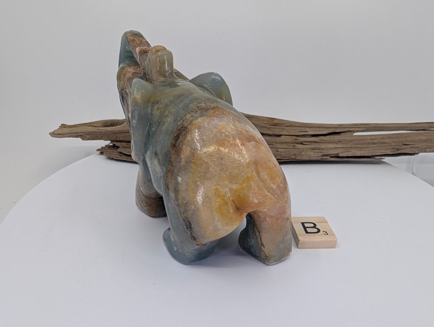 Rear view of Blue Onyx elephant specimen B3 showcasing the broad golden-cream mineral saddle and high-gloss polish.