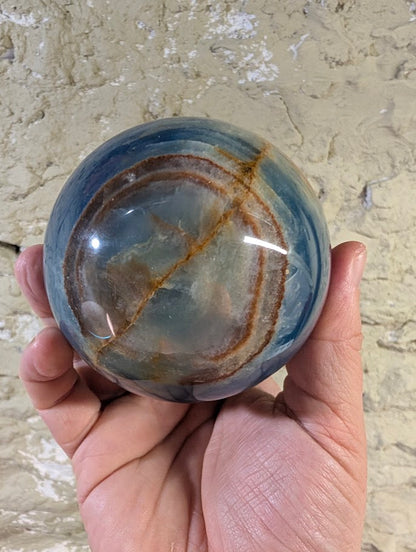 Circular iron seam ring pattern across one face of the sphere