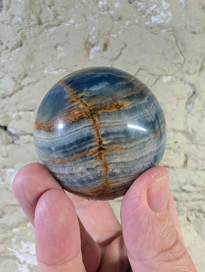 Blue Onyx Sphere 60mm with visible golden cross seam