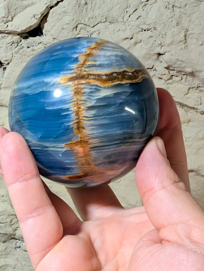 Natural banded calcite sphere with circular horizontal golden seam detail
