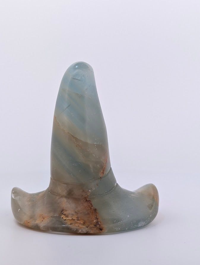 Angled view of blue onyx witch hat carving