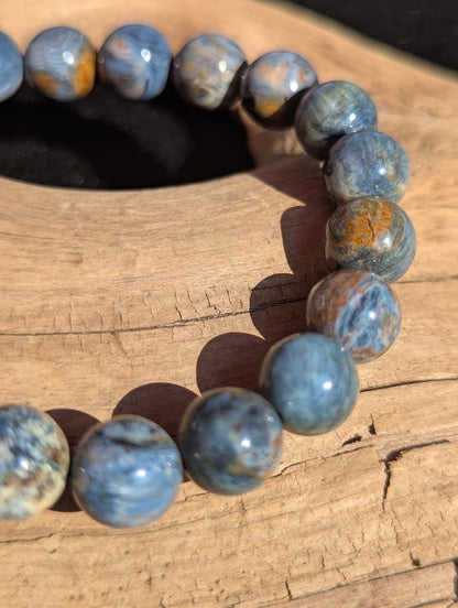Macro detail of 9mm Blue Pietersite beads highlighting the distinct tiger's eye and hawk's eye natural blending.