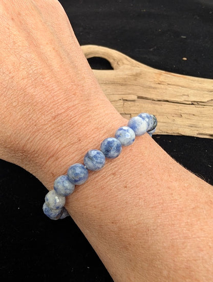 8mm faceted Blue Point Stone beaded stretch bracelet worn on a wrist for size scale.