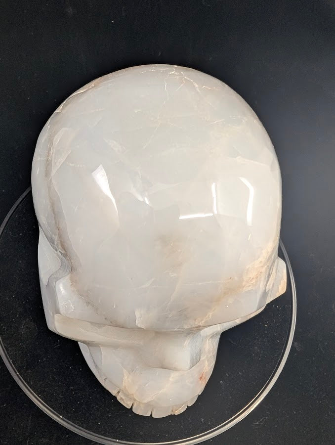 Top view of Blue Rose Quartz Skull with high-gloss polish and natural veils
