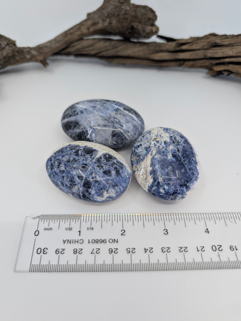 Blue sodalite palm stones with ruler for size reference