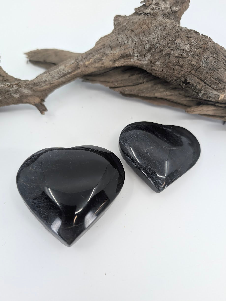 Pair of Blue Tiger Eye hearts showing dark midnight blue color.